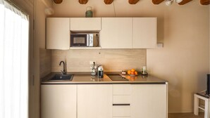 A compact kitchen with a built-in microwave, a sink, and a coffee machine. - Pet friendly apartment in Longare (Longare)