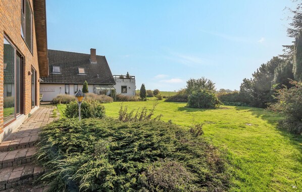 Stroll through the tranquil grounds to the entrance of this charming two-story home.
