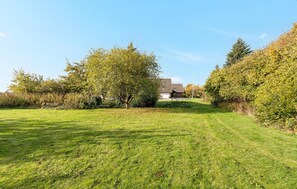 Surrounded by lush trees, this serene property offers a peaceful atmosphere.