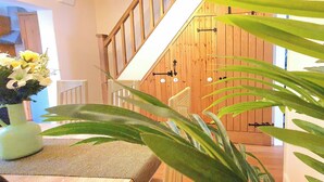 A staircase with wooden railings and a door with a black handle. - Inviting 2-bed Cottage in Windsor (Windsor)