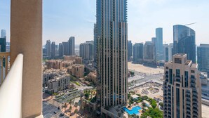A high-rise building with a modern design, surrounded by other high-rise buildings and a beach area. - Lux BnB I 29 Burj BLVD I Downtown Views (Dubai)