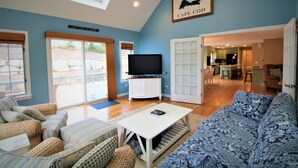 A living room with a TV, sofa, and a sign that reads "ON THE ELBOW". - Sprawling Home With Great Outdoor Space (2288) (Harwich Port)
