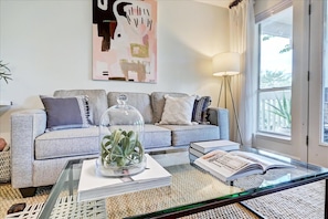 Relax in this stylish living room with a sofa, coffee table, and floor lamp.