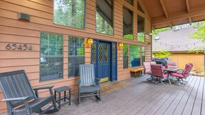A wooden deck with outdoor furniture, a covered patio, and a house number 65454. - Huge Mountain Chalet - Gourmet Chefs Kitchen - Pool - One Block From Sandy River (Rhododendron)