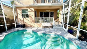 A backyard with a swimming pool, a covered patio, and a small outdoor seating area. - 4 Bedroom Pool Home Siesta Key (Siesta Key)