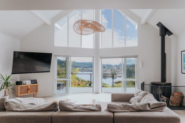 Open-plan living with lake views and log fire