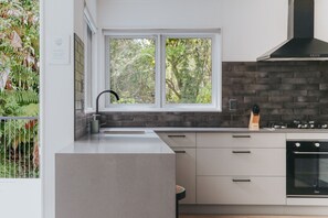 Kitchen sink with bush outlook - Architectural Lakehouse | Panoramic Views | Boat Mooring | Space for 14 (Okere Falls)