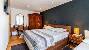 A bedroom with a large bed, wooden wardrobe, bedside table, and a mirror. - Beautiful home in Lokvicici (Lokvicici)