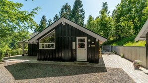 A small wooden cabin with a gabled roof, a front door, and a window. - 3 bedroom lovely home in Ebeltoft (Ebeltoft)