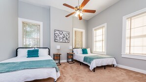 A bedroom with two beds, a ceiling fan, and large windows with blinds. - Downtown Macon Duplex-Walk to Concerts, Food & Nightlife (Macon)