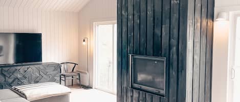 Smart-tv, een open haard, boeken en een printer