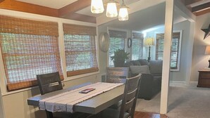 A dining area with a wooden table, chairs, and a ceiling light fixture. - Cozy 3 bed, 2 bath home close to historic downtown Hannibal (Hannibal)