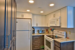 Fridge, microwave, oven, stovetop - BEACH HAVEN -Luxury Oceanfront 2/2 Condo PeckPlaza9SE Heated Pool, Amazing Ocean Views (Daytona Beach)