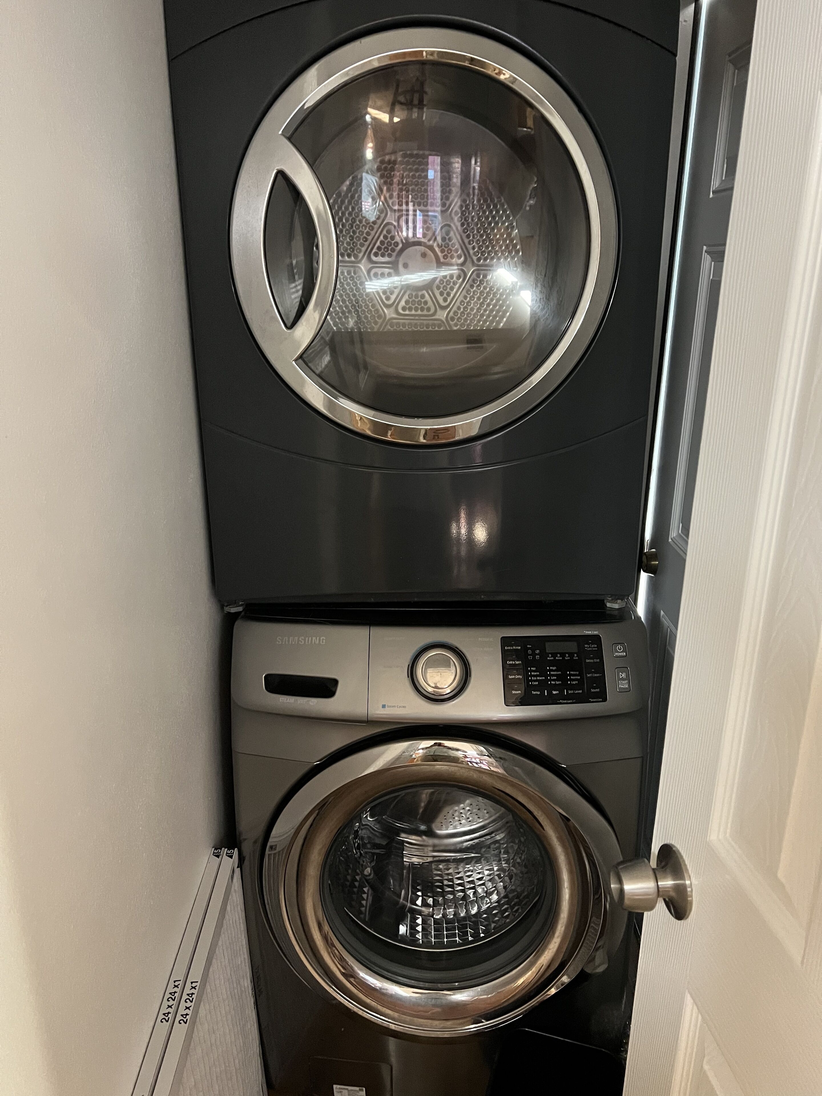 A front view of a stacked washer and dryer unit.
