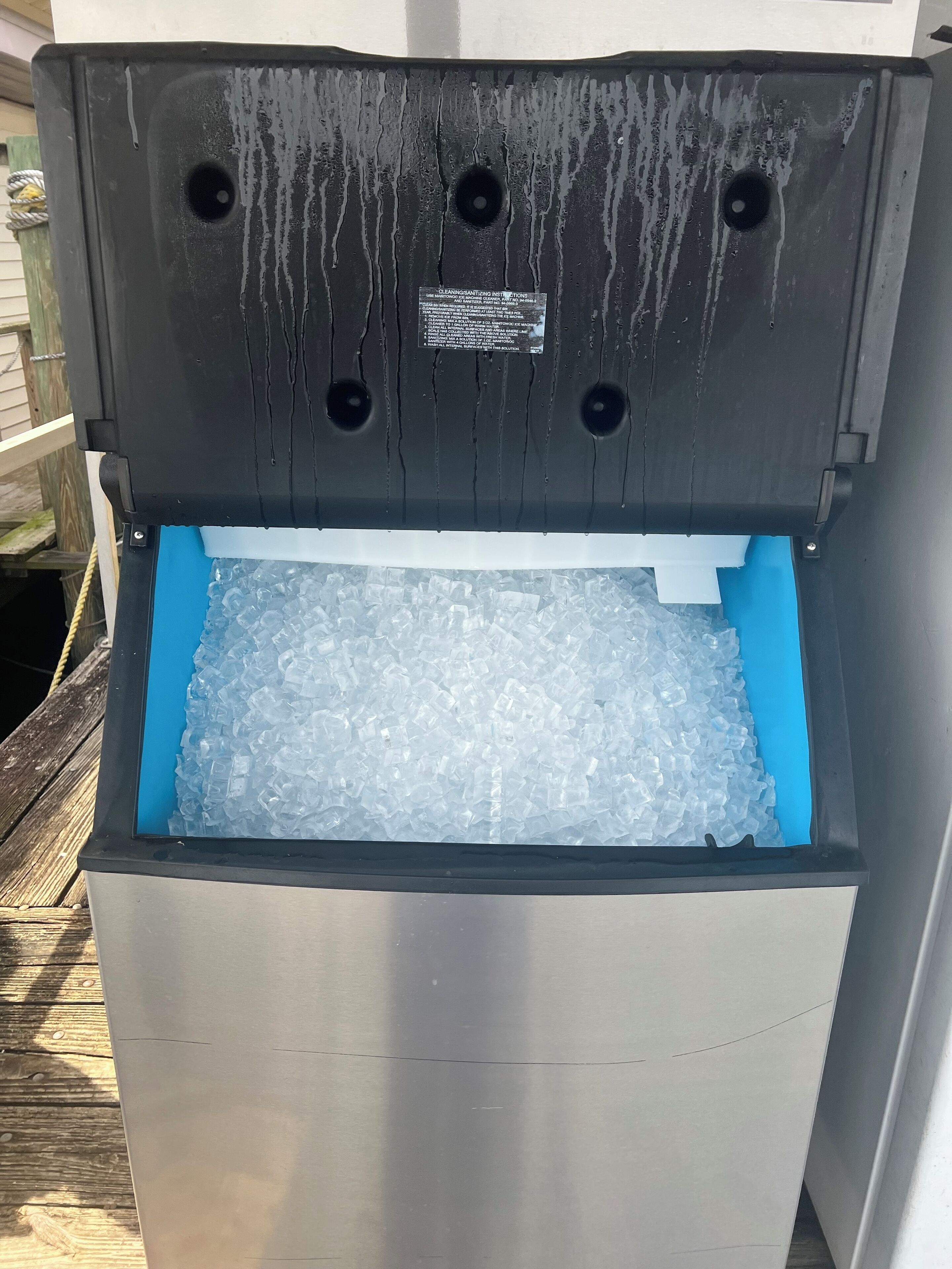 A freezer with a blue interior and a black exterior.