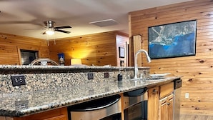 A kitchen with wooden cabinets, granite countertops, stainless steel appliances, and a wooden floor. - NEWLY RENOVATED Houseboat Located in Venice Marina (B Dock) (Venice)
