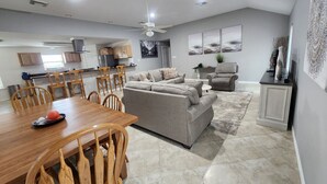 A spacious living area with a dining table, sofa, and chairs. - Bounty Pet Friendly · Entertain & Relax at our Beach Home - Pet Friendly (Galveston)