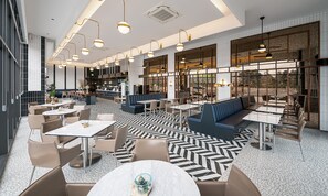 A modern restaurant with a mix of seating options including tables, booths, and a bar area. - Jeonju The May Hotel (Jeonju)