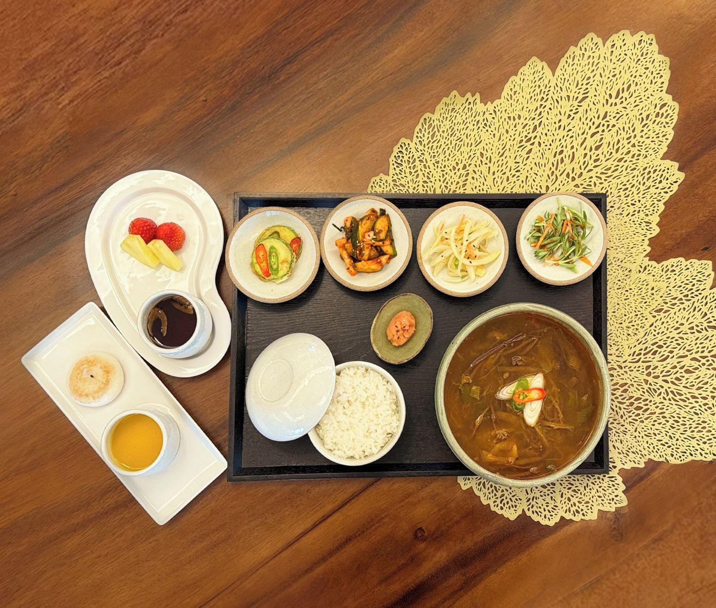 A tray with various dishes including rice, soup, and several side dishes.
