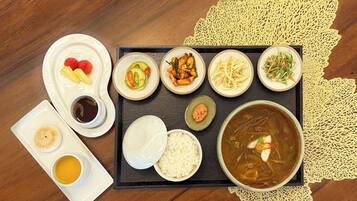 A tray with various dishes including rice, soup, and several side dishes.