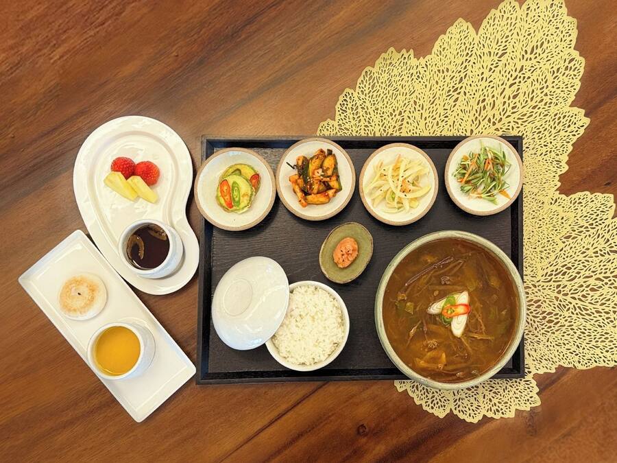 A tray with various dishes including rice, soup, and several side dishes.