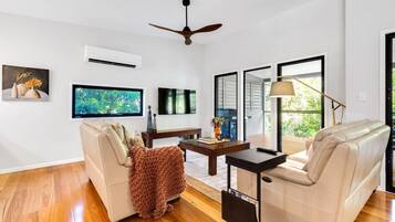 A modern living room with a sofa, coffee table, and TV.