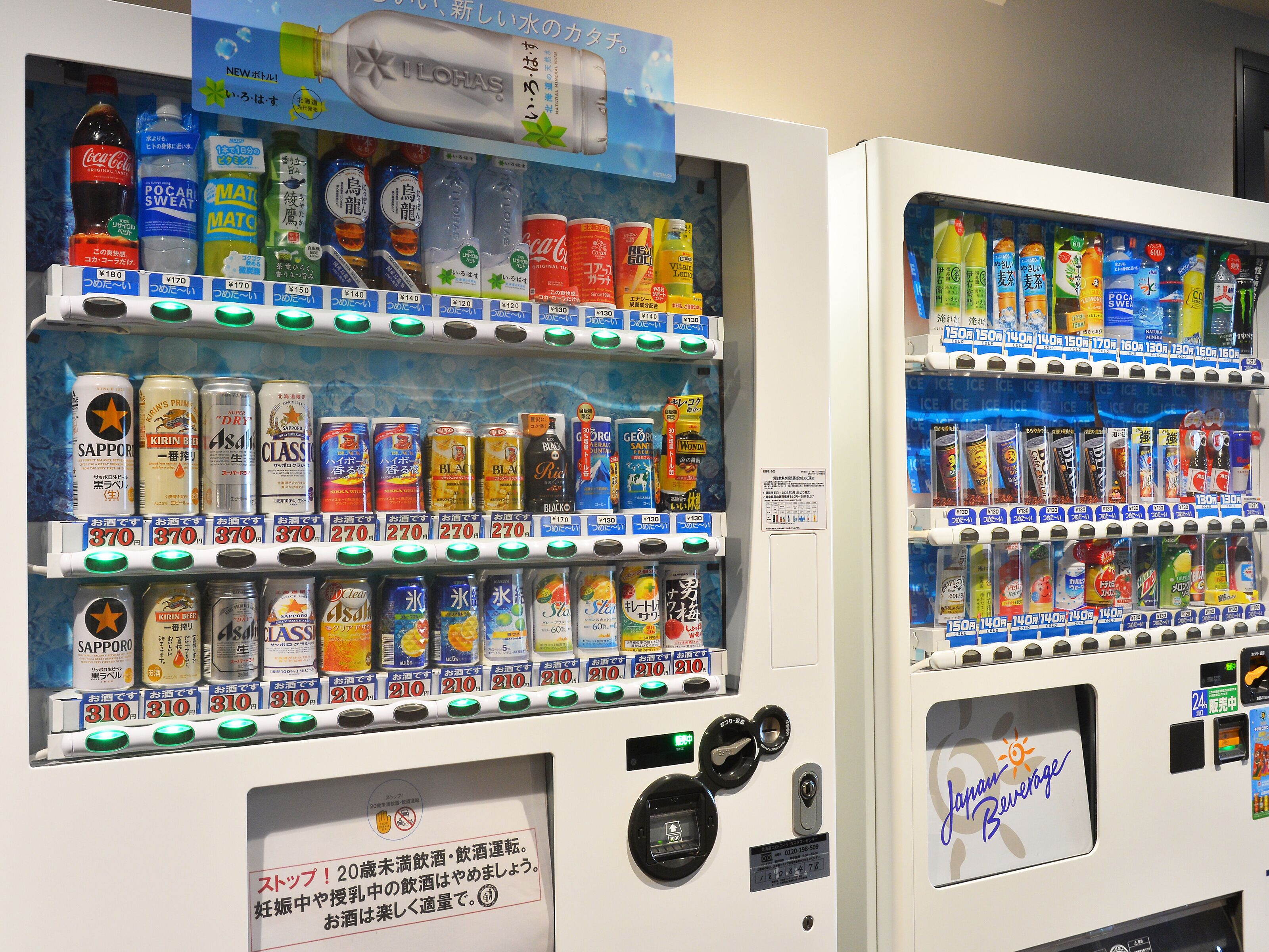 Vending machines stocked with beverages and snacks.