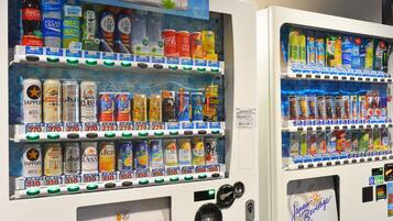Vending machines stocked with beverages and snacks.