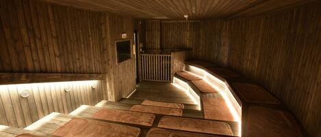 A wooden interior with a long bench and a reception area.