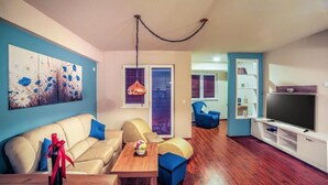A modern living room with a sofa, coffee table, and TV stand.