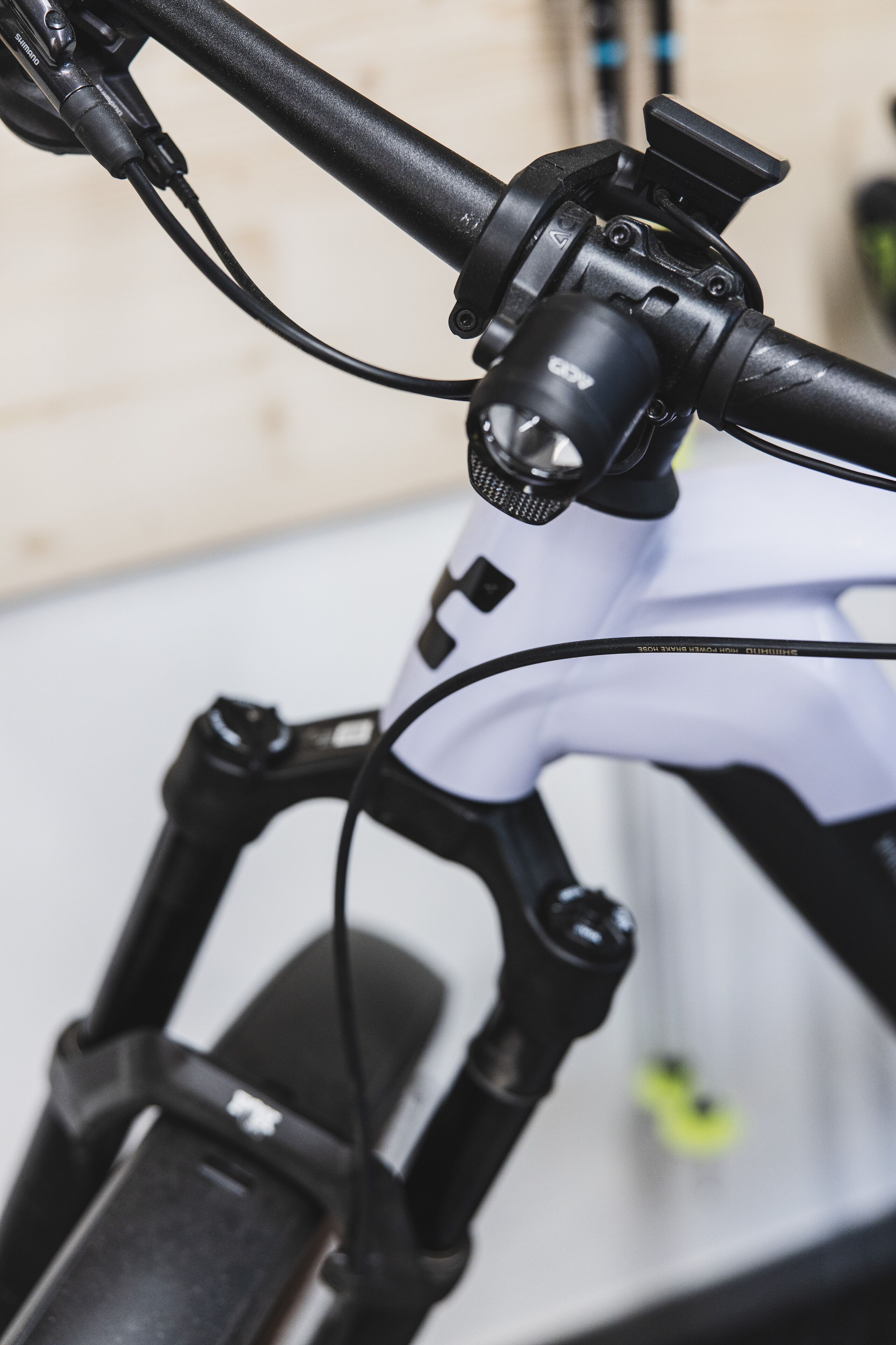 A close-up of a bicycle's handlebars and front suspension system.