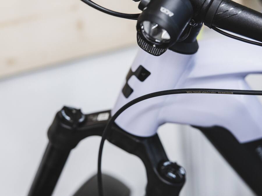 A close-up of a bicycle's handlebars and front suspension system.