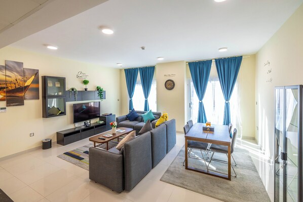 Deluxe Apartment | Living area | 55-inch LED TV with satellite channels, TV