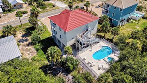 A coastal property with a swimming pool, multiple buildings, and a beach view. - Paradise Falls here! 4 BR, Elevator, Pool, across the street from beach (ST GEORGE ISLAND)