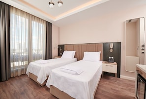 Deluxe Corner Room | Minibar, desk, laptop workspace, soundproofing