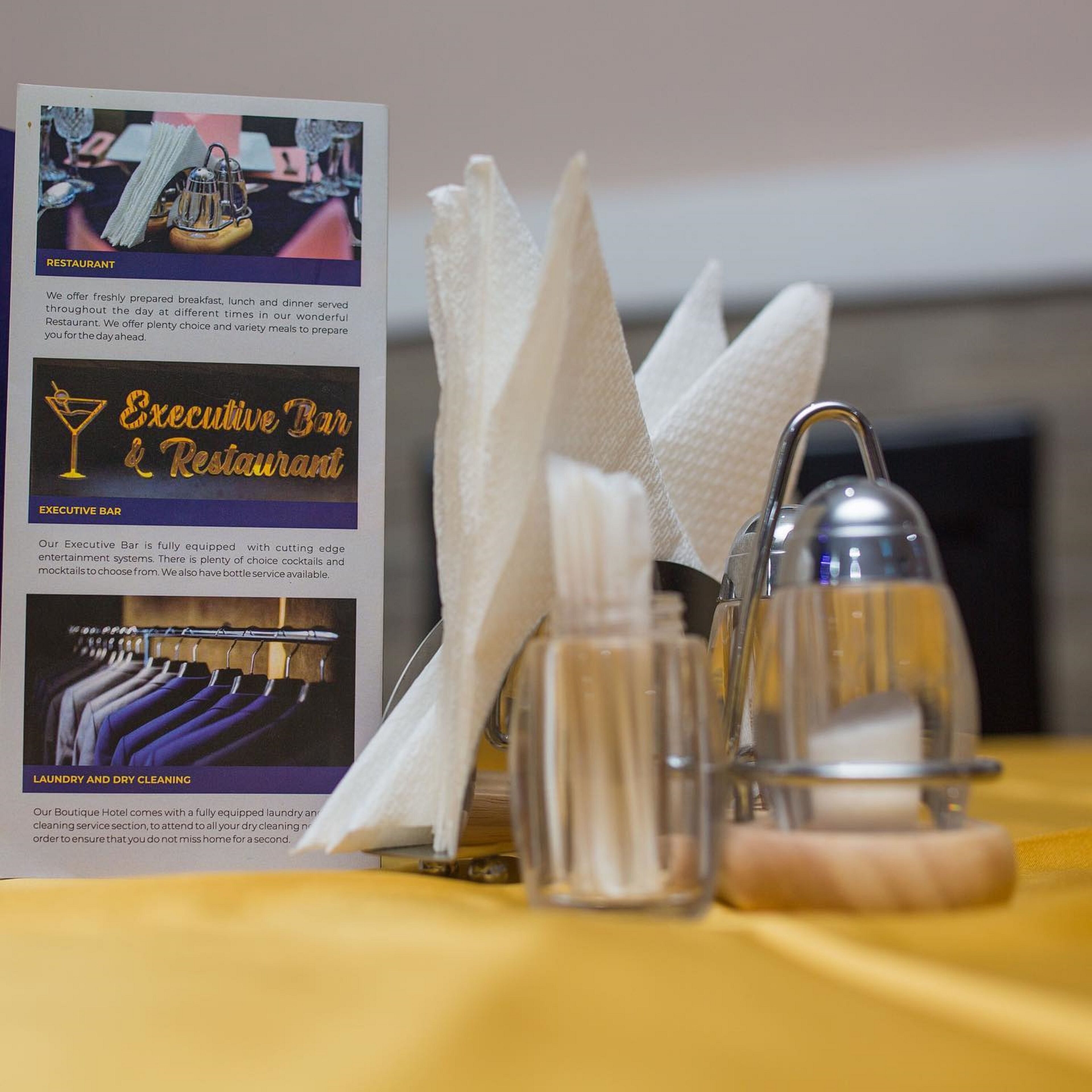 A table with a menu detailing breakfast, lunch, dinner, and the Executive Bar.