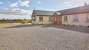 A two-story building with a gravel driveway and a small garden area. - Host & Stay | The Stables (Yarm)