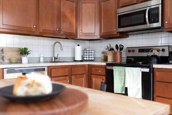 Enjoy cooking in this fully equipped kitchen with a microwave, stove, and dishwasher.
