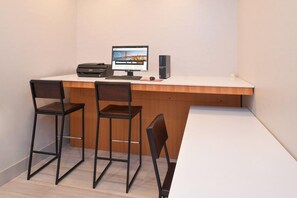 A small office space with a desk, two chairs, a computer, and a printer. - Holiday Inn Express and Suites Austin NW Lakeline an IHG Hotel (Austin)