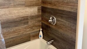 A bathroom with a bathtub, a shower, and a toilet. - Large Cabin with Stunning View - Fire Pit, Relax & Unwind  (Gallipolis)
