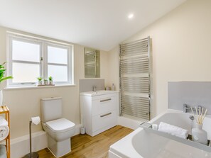 A modern bathroom with a toilet, sink, and bathtub. - Toppesfield Hall Luxury Cottage With Hot Tub (Halstead)