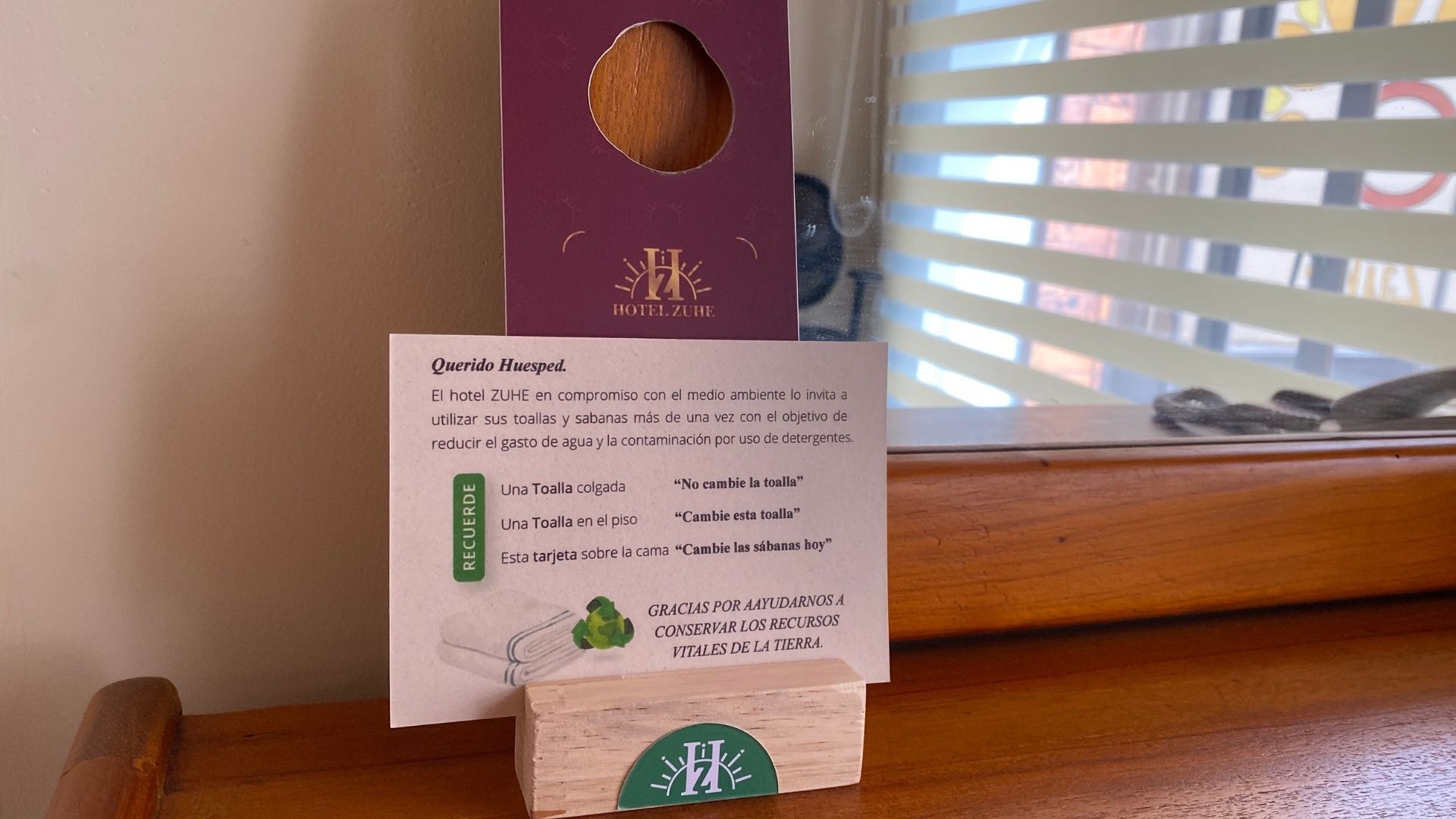 A hotel sign with a message about towel and linen reuse to conserve water and reduce detergent use.
