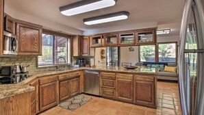 A spacious kitchen with wooden cabinets, a stainless steel dishwasher, and a large island. - Pine Mountain Club Getaway w/ Foosball Table! (Pine Mountain Club)