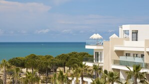 A modern building with a balcony overlooking a beach and the sea. - Melia Durres Albania (Ishëm)