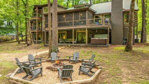 A cabin with a deck, a fire pit, and outdoor seating. - The Grande Lodge- Riverfront, Fiber, HotTub, Fish, DogOK, Game Room, Movie Room (Ellijay)