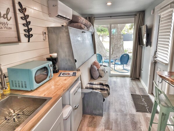 Fridge, microwave, coffee/tea maker, cookware/dishes/utensils