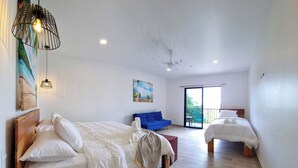 A spacious bedroom with two beds, a balcony, and a ceiling fan. - Hilltop Treehouse amazing views near playa Avellanas Tamarindo (Pinilla)
