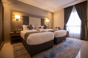 A hotel room with two beds, a large mirror, and a view of the city.