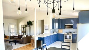A modern kitchen with blue cabinets, a white countertop, and a built-in oven. - Large Home + Sleeps 20 + Hot Tub + Backyard Oasis + Optional add-on CABOOSE (Denver)