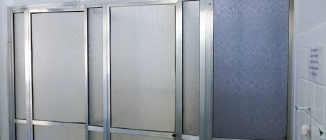 A row of metallic, insulated lockers with a frosted glass door, likely for storage or security purposes.